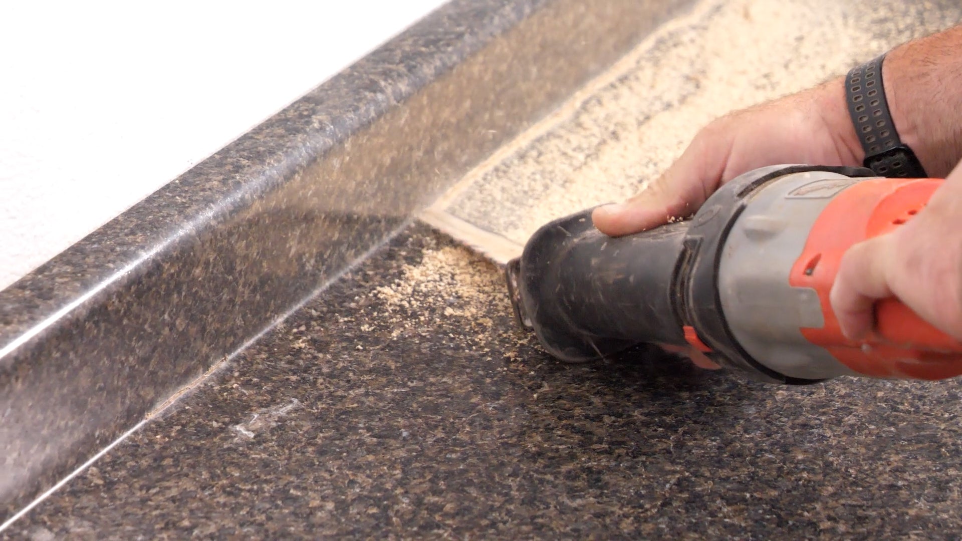 Hand cutting into the countertop with a panel saw