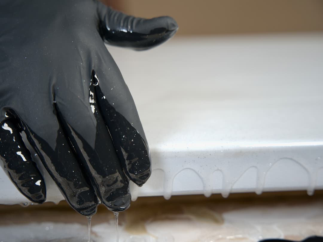 Hand spreading epoxy over the counter edge
