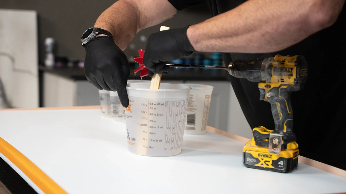 Scraping sides of epoxy mixing cup