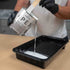 Person pouring Apex Poly Fuse countertop primer into a black roller container.