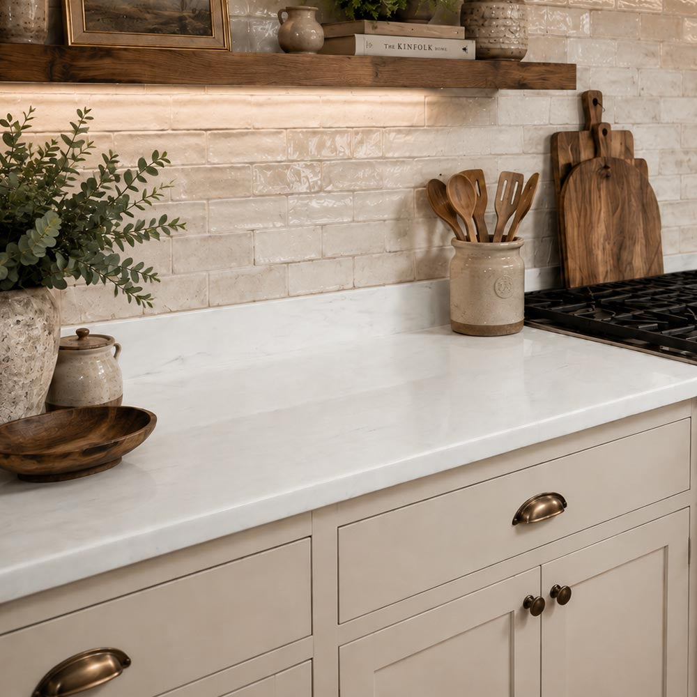 APEX Kitchen counter with white countertop, wooden cutting boards, and decorative items.