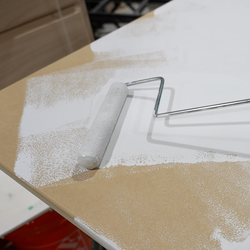 Roller applying APEX Poly Fuse primer to a countertop surface 