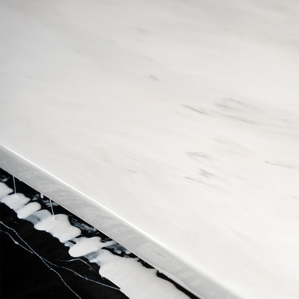 Close-up of an APEX white marble countertop with a blend of white and black patterns.