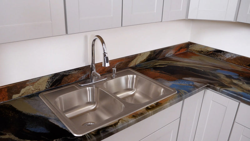 A finished epoxy countertop with a stainless steal sink