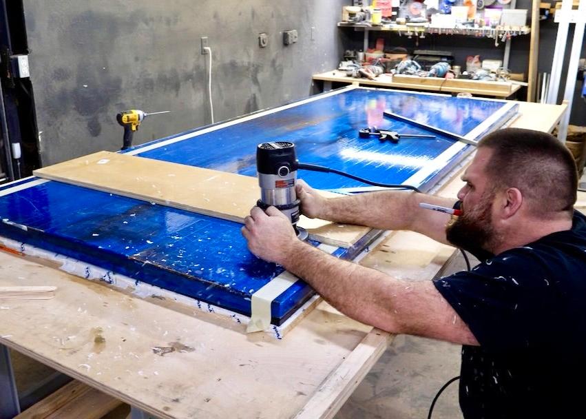 router grooves into river table for steel bars