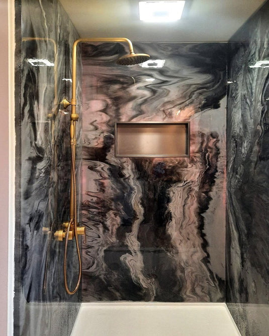 Black, Grey, and Pink Marble Shower with Gold Accent Shower head