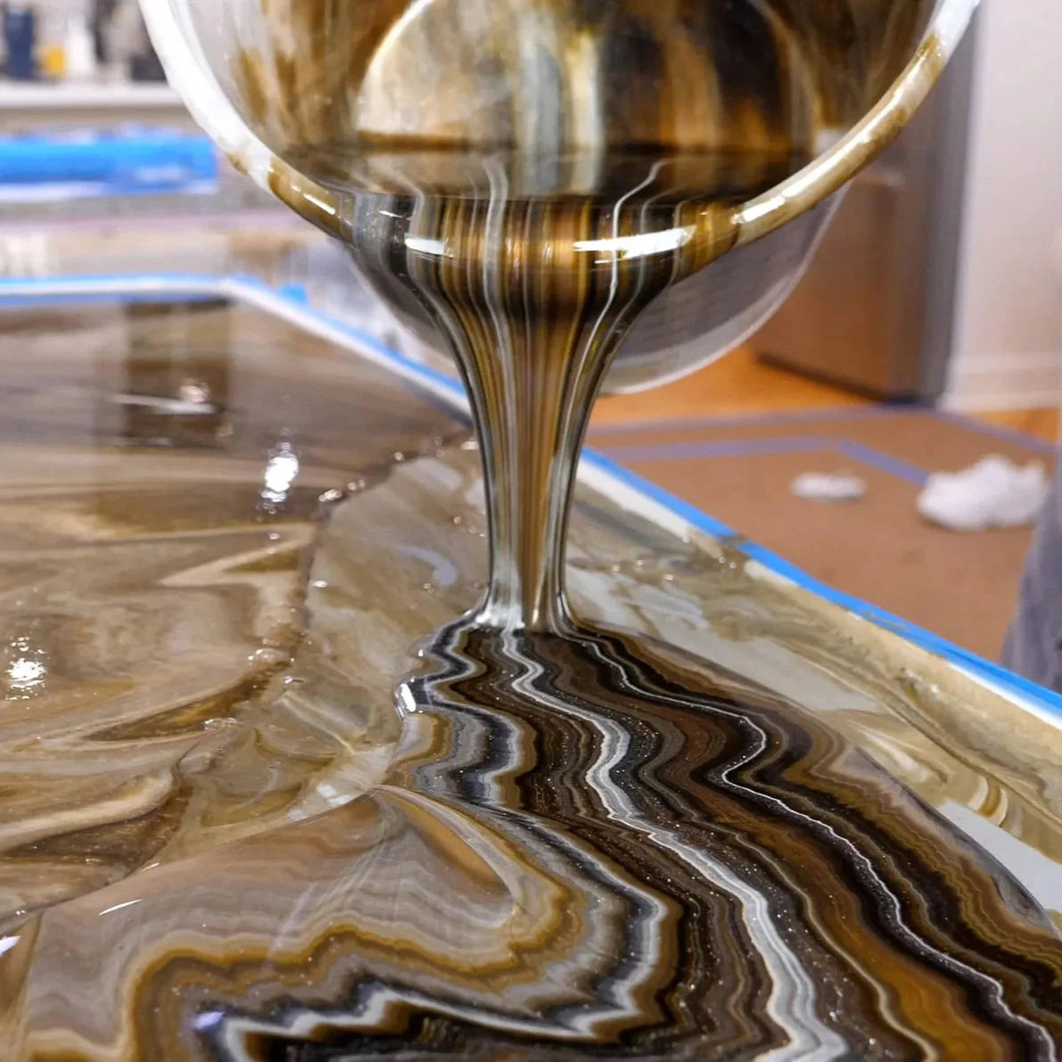 Pouring Gold, Black and White Epoxy on a countertop