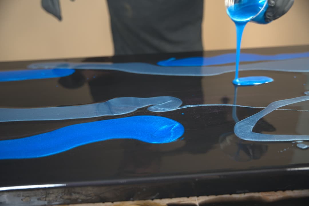 pouring blue epoxy ribbons on counter