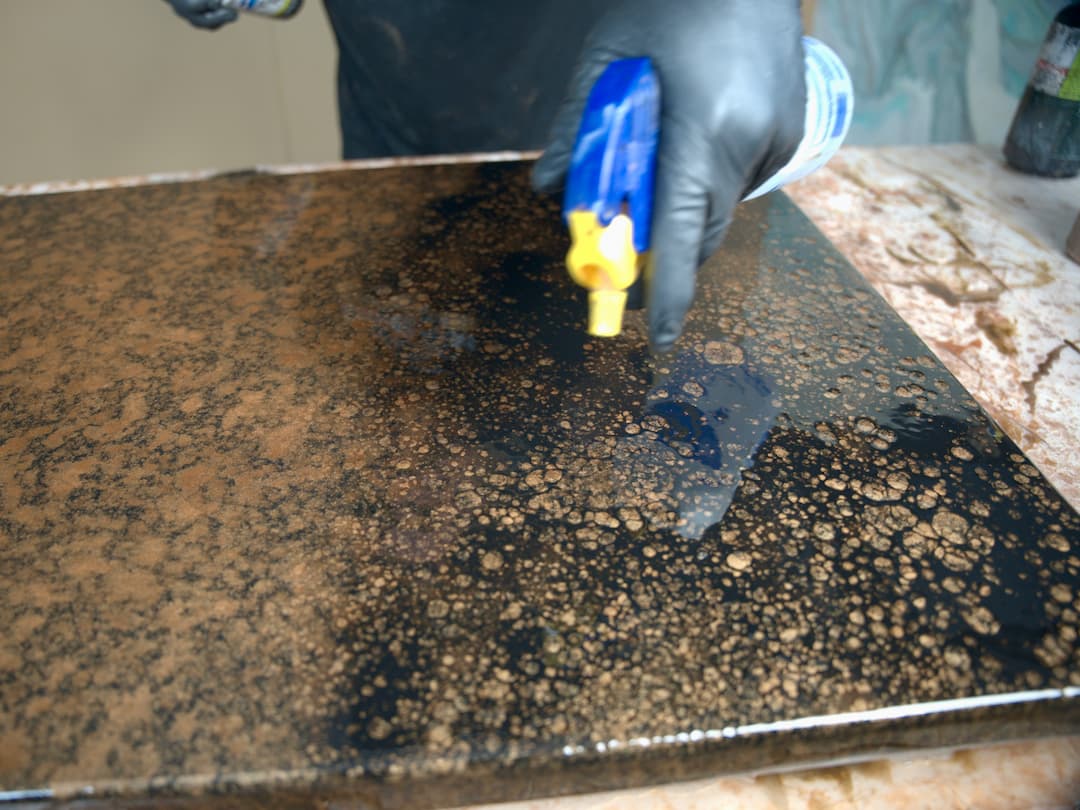 spray alcohol over black spray paint for faux granite effect